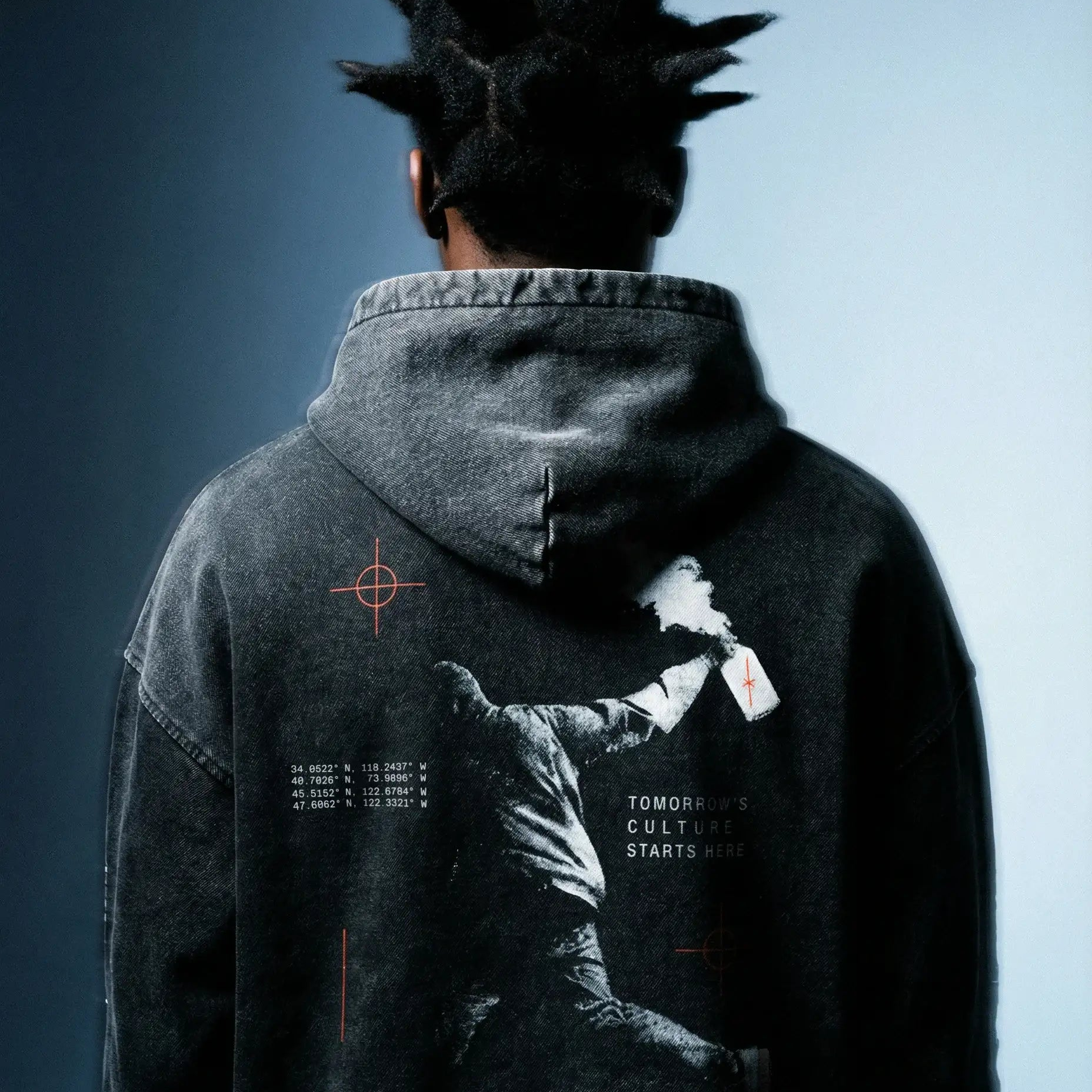 Streetwear hoodie with graphic of protester, spray paint, and bold cultural statement on back