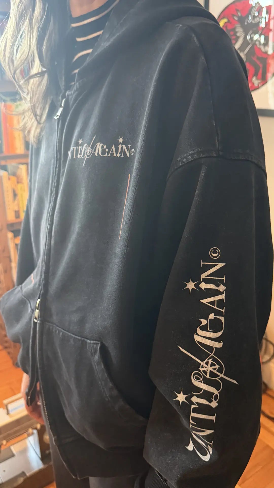 Black UNTIL/AGAIN hoodie with logo on chest and sleeve, limited drop streetwear